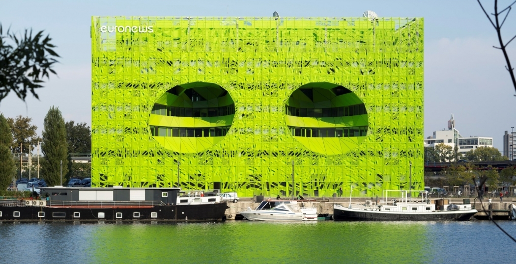 Gifgroene gevel voor Euronews hoofdkwartier in Lyon